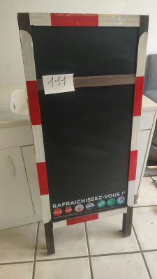 a black and red sign on the floor in the kitchen