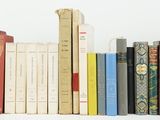 many books that are lined up on a shelf