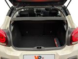 the back of a car with the trunk open and a laptop in the trunk