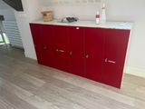 a red cabinet in the middle of a room