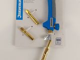 a blue and gold tool that is laying on a white surface
