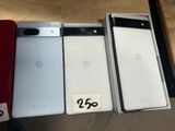 Trois téléphones Google Pixel sont posés les uns à côté des autres sur une table