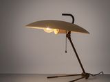 une image représentant une lampe posée sur une table, dont la lumière est allumée