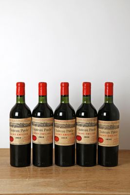 six bouteilles de vin sont alignées sur une table en bois