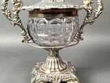 an antique silver plated bowl with a lid on a stand
