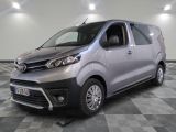 the silver van is parked on a checkered floor in a room