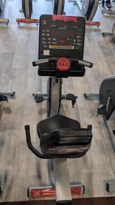a row of stationary exercise bikes in a gym