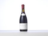 the bottle of wine is sitting on the table with a white background