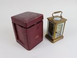 a small red box with a clock on it next to a smaller red box