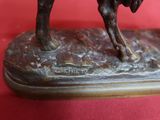 a statue of a man riding a horse on a red surface