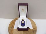 a bottle of perfume sitting in a box on a table