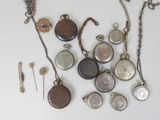 many different types of pocket watches on the table
