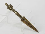 a small metal object with a gold handle on a clear stand