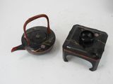 two small teapots sitting next to each other on a table