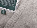 the label of a sweater is displayed on the back of a sweater