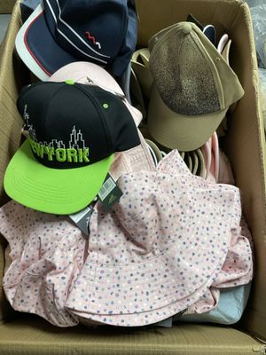 une boîte en carton remplie de chapeaux et de vêtements