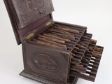 an old wooden box that has a bunch of cigarettes in it