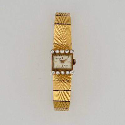 an image of a gold watch with diamonds on it