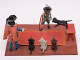 toy figurines of a man with cats and a dog on a rug