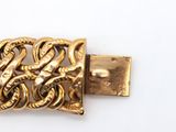a close up of a gold buckle on a white surface