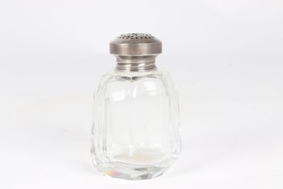 a salt shaker with a silver top on a white background
