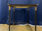 a small table with a wooden top on a wooden floor