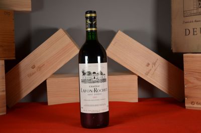 a bottle of wine sitting on a table next to wooden blocks