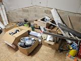 a pile of boxes and tools on the floor in a room