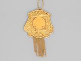an image of a gold pendant with a picture of a woman