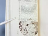 an open book with a pencil sticking out of it