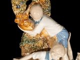 a figurine of a man and two children on a tree stump