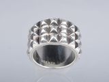 a close up of a silver ring on a white surface