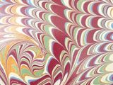 marbled paper with a gold border on top of it