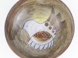 a small bowl with a bird painted on it