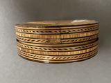 a close up of a stack of wooden rings on a table