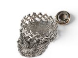 a metal basket with a chain around it on a white surface