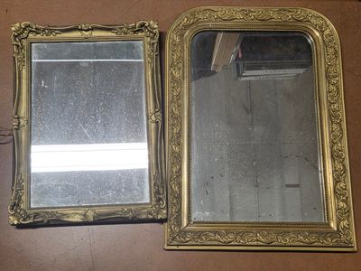 two mirrors that are sitting next to each other on a table