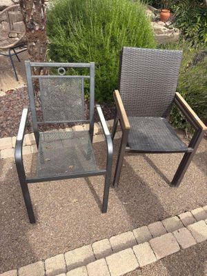 two chairs sitting next to each other on a patio