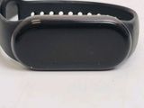 the back of a black smart bracelet with pearls on it