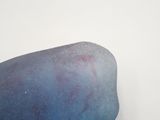 a blue and purple object sitting on a white surface
