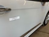 a close up of a car door with a sticker on it