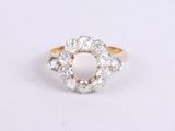 a close up of a diamond ring on a white surface