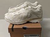 the white sneakers are sitting on top of a box on a table