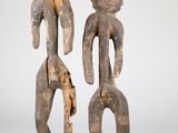 pair of carved wooden figures of a man and a woman