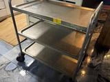 a metal cart that is sitting in the middle of a room