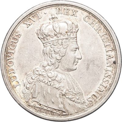 a close up of a silver coin with a crown on it