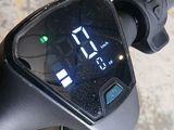 a close up of a motorcycle with a digital clock on the handlebar