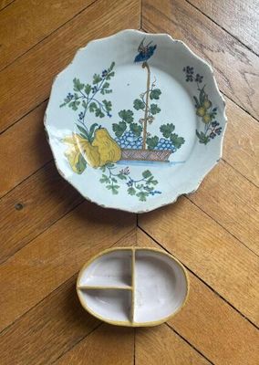 a small plate with a bird on it next to a small plate with a bird on it