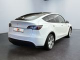 the back of a white tesla model x parked in a showroom