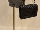 chanel handbags on display in a store window